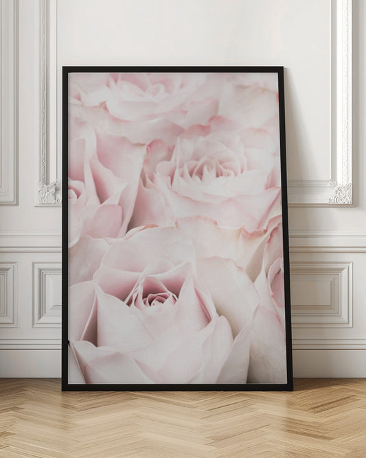 A close-up, soft-focus photograph of a bouquet of delicate, light pink roses filling the entire frame, enclosed in a simple black border. Poster