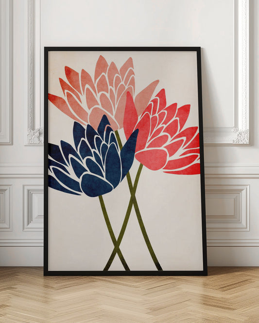 A modern graphic art print of three stylized flowers in navy blue, coral red, and salmon pink against a textured off-white background, all enclosed in a thin black frame. The flower petals have white outlines, and their dark green stems cross at the bottom. Artwork