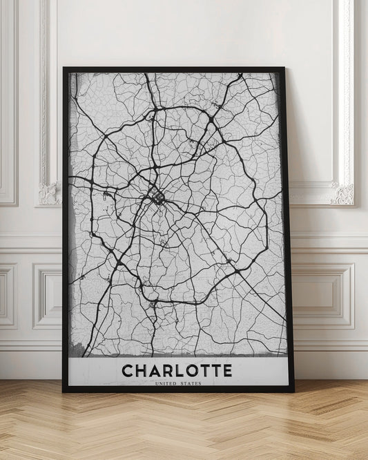 A minimalist black and white street map of Charlotte, North Carolina. The map highlights the major roads and highways as thick black lines on a distressed, crackled white background. The artwork is framed in black with the word 'CHARLOTTE' printed in bold capital letters at the bottom. Poster