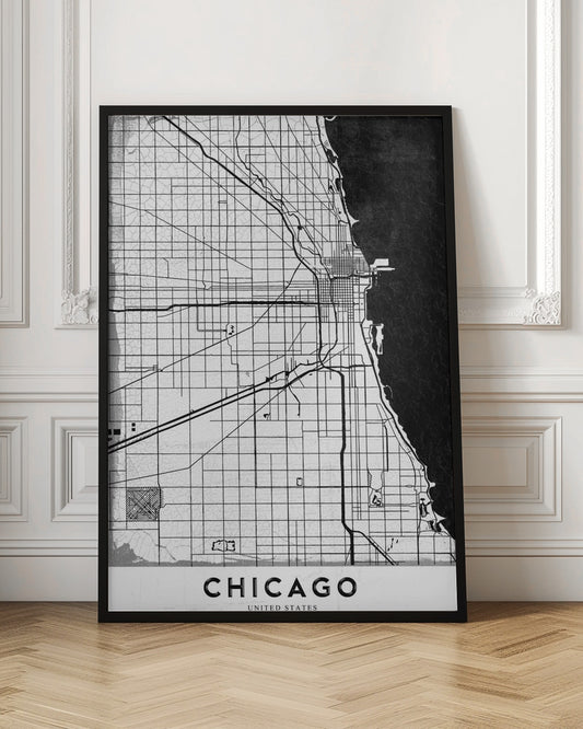 A minimalist black and white map of Chicago, featuring a grid street layout, major thoroughfares, and the shoreline of Lake Michigan. The map has a subtle crackled texture, is enclosed in a black frame, and has the word 'CHICAGO' in capital letters at the bottom. Decor