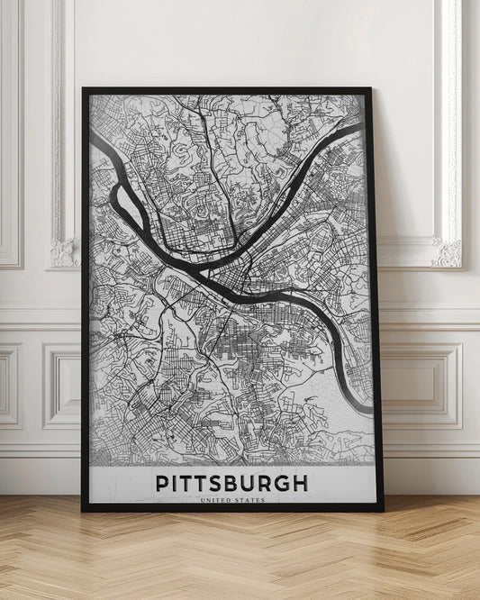 A minimalist black and white map of Pittsburgh, Pennsylvania, in a black frame. The map details the city's streets and the confluence of the Allegheny, Monongahela, and Ohio rivers. The word 'PITTSBURGH' is printed in a bold, sans-serif font at the bottom. Decor