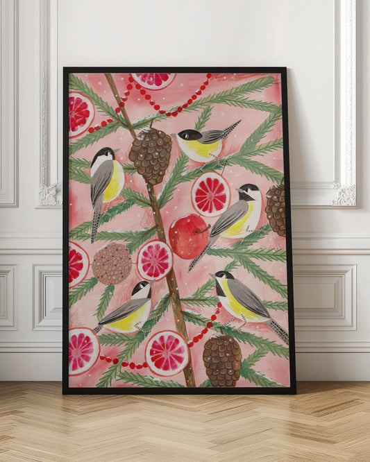 A festive illustration of a pine branch against a pink background, decorated with chickadees, pinecones, slices of red grapefruit, a red apple, and a red beaded garland. The scene has a light dusting of snow, creating a whimsical winter or holiday feel. Decor