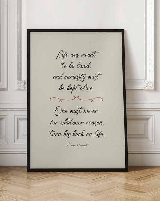 A framed inspirational quote by Eleanor Roosevelt in a black cursive font on a textured beige background. The quote reads: 'Life was meant to be lived, and curiosity must be kept alive. One must never, for whatever reason, turn his back on life.' A red decorative flourish separates the two stanzas. Decor