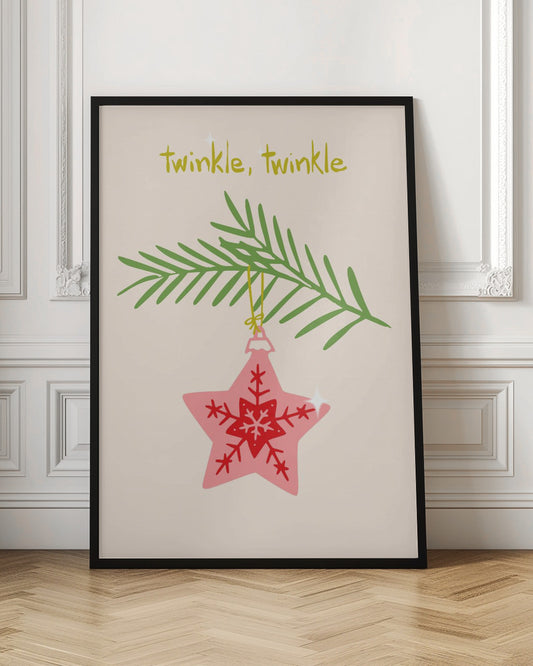 A framed piece of art with a light cream background featuring the words 'twinkle, twinkle' in a playful yellow-green font. Below the text, a pink star-shaped Christmas ornament with red snowflake designs hangs from a green pine branch. Print