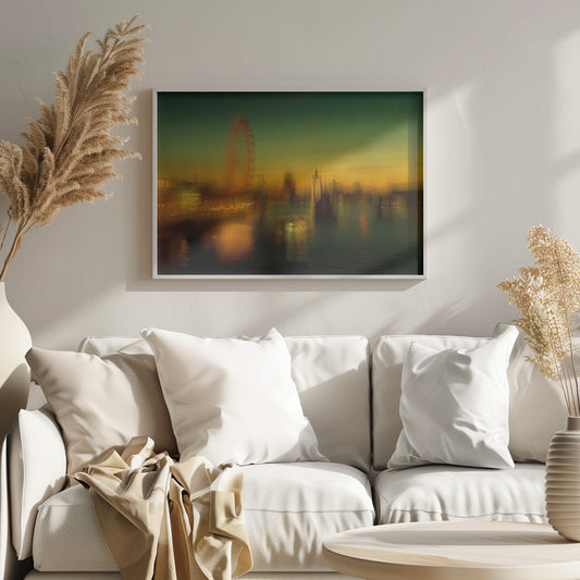 A dreamlike, blurred photograph of the London skyline at dusk, with the glowing orange London Eye on the left and the hazy silhouette of the Houses of Parliament across the River Thames. The sky shifts from a deep green to a warm golden yellow, and the city's lights cast shimmering reflections on the water. Decor