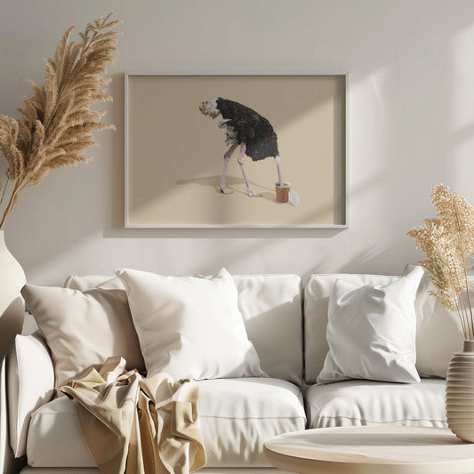 A humorous and surreal image of a black and white ostrich with its head buried inside a disposable coffee cup, set against a plain beige background and enclosed in a silver frame. Decor