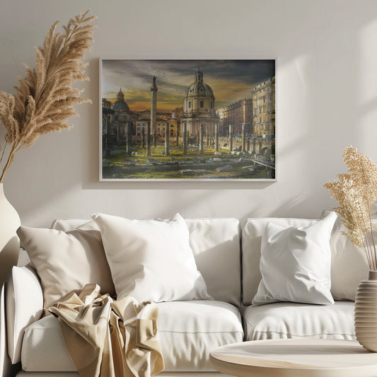 A framed photograph of Trajan's Forum in Rome, Italy, during a dramatic sunset. The foreground is filled with ancient stone columns and ruins on a grassy field, leading to the prominent Trajan's Column and the domed Church of the Most Holy Name of Mary against a golden and dark cloudy sky. Wall Art
