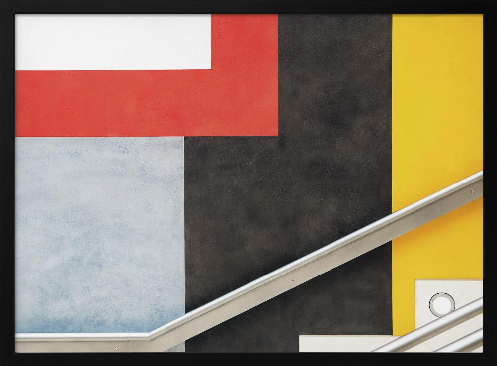 A framed abstract art piece featuring a composition of large, solid-colored geometric shapes in red, yellow, black, white, and light gray. A silver handrail cuts diagonally across the lower portion of the image, adding a sharp line and a sense of architectural space. Artwork