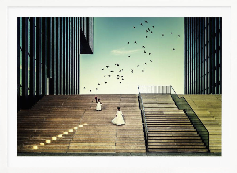 A framed piece of art depicting two young girls in white dresses climbing a vast, modern concrete staircase flanked by two towering, dark buildings. A large flock of birds flies through the teal sky above them, adding a sense of movement to the structured, architectural scene. Poster