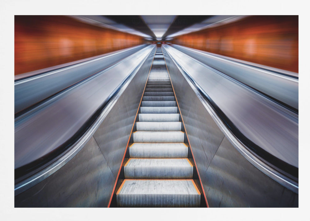 A symmetrical, low-angle photograph looking up a very long escalator, creating a strong sense of perspective towards a vanishing point. The orange walls are motion-blurred, suggesting speed, while the metallic steps in the center remain clear. Decor
