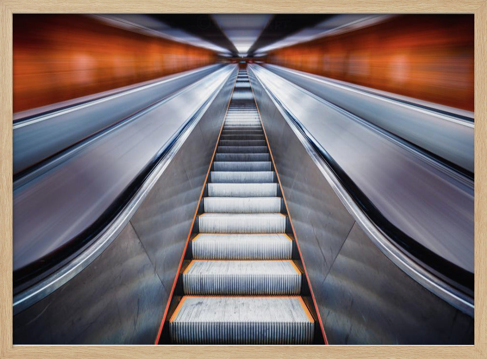 A symmetrical, low-angle photograph looking up a very long escalator, creating a strong sense of perspective towards a vanishing point. The orange walls are motion-blurred, suggesting speed, while the metallic steps in the center remain clear. Decor