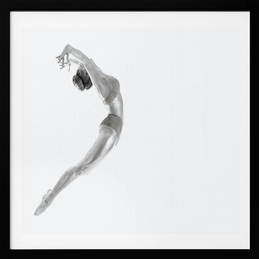 A minimalist black and white photograph of a graceful dancer frozen in mid-air, her body arched backward in an elegant C-shape against a stark white background. The artwork is presented in a light wood frame. Decor
