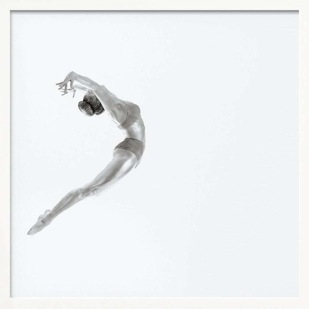 A minimalist black and white photograph of a graceful dancer frozen in mid-air, her body arched backward in an elegant C-shape against a stark white background. The artwork is presented in a light wood frame. Decor