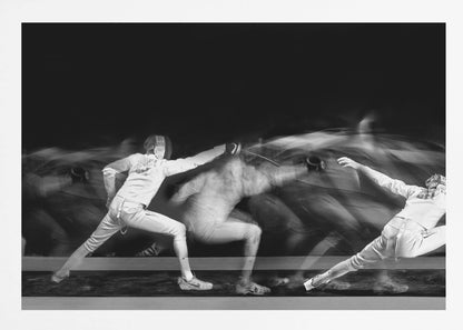 A framed, dramatic black and white photograph using long exposure to capture a fencer in motion. The fencer, in full white gear, lunges forward, their form crisp at the end of the movement while a ghostly blur trails behind, illustrating their rapid advance against a black background. Decor
