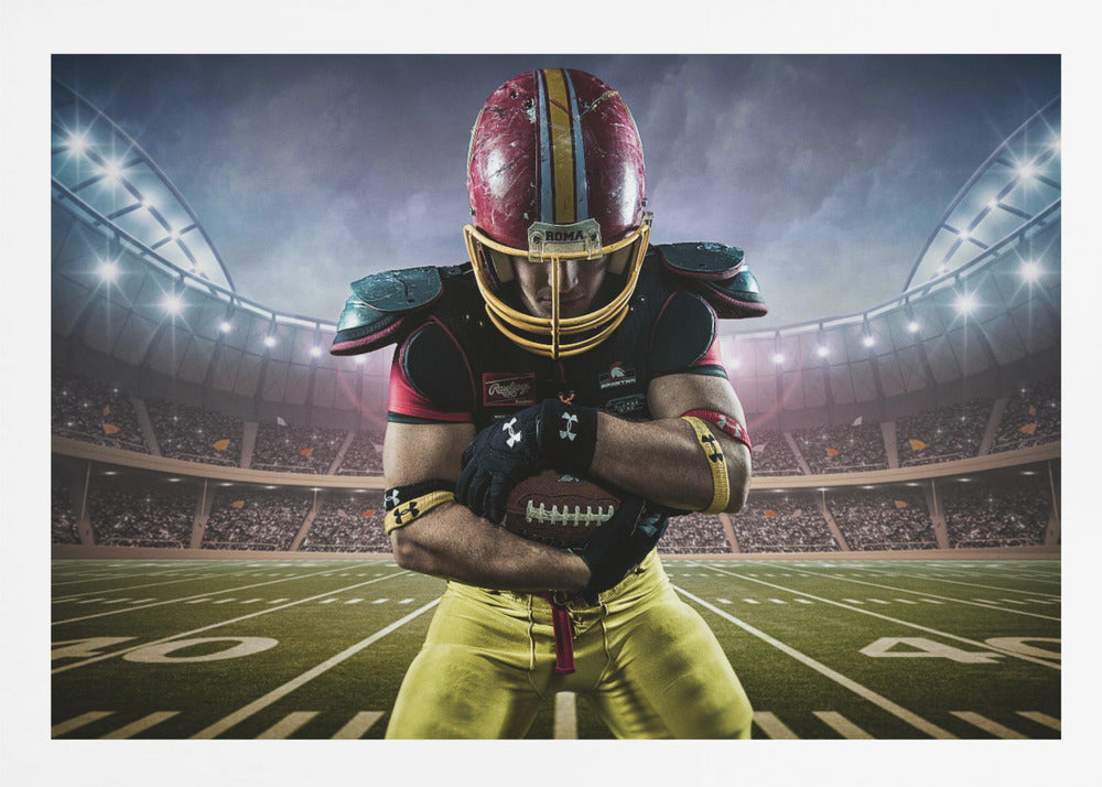 A framed poster of a determined football player in a red and yellow uniform standing on a field in a packed stadium. He is holding a football close to his chest with his head bowed, under bright stadium lights. Decor