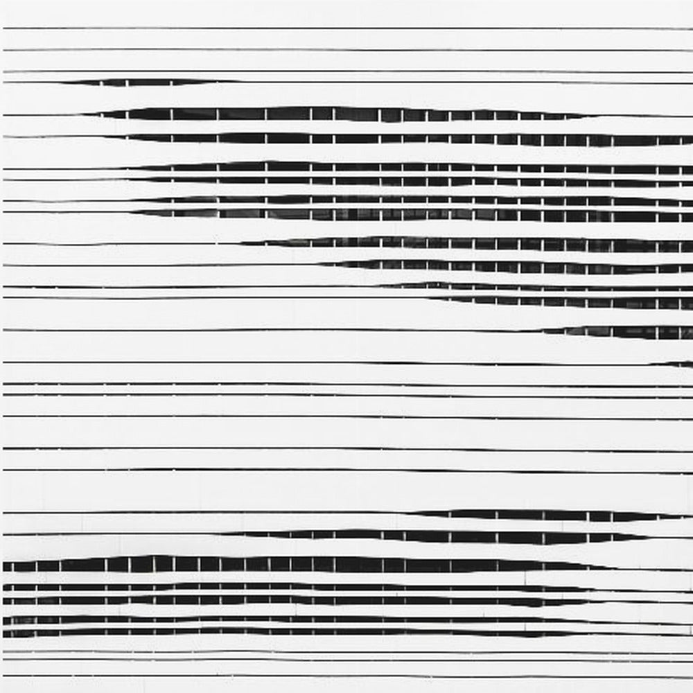 A framed abstract artwork featuring black horizontal lines on a white background. The lines vary in thickness and some sections are broken by vertical white spaces, creating a rhythmic and textured pattern. The piece is enclosed in a simple, light-colored wood frame. Poster