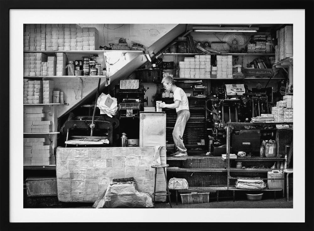 A vintage art print depicting a small, old-fashioned printing shop interior, showcasing antique machinery and a nostalgic atmosphere. Artwork