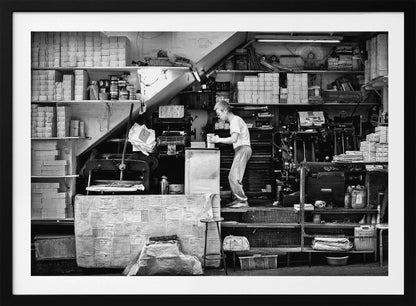 A vintage art print depicting a small, old-fashioned printing shop interior, showcasing antique machinery and a nostalgic atmosphere. Artwork