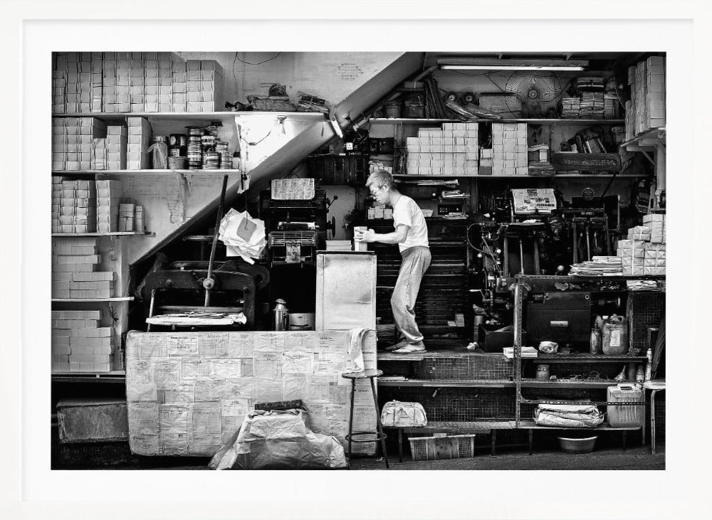 A vintage art print depicting a small, old-fashioned printing shop interior, showcasing antique machinery and a nostalgic atmosphere. Artwork