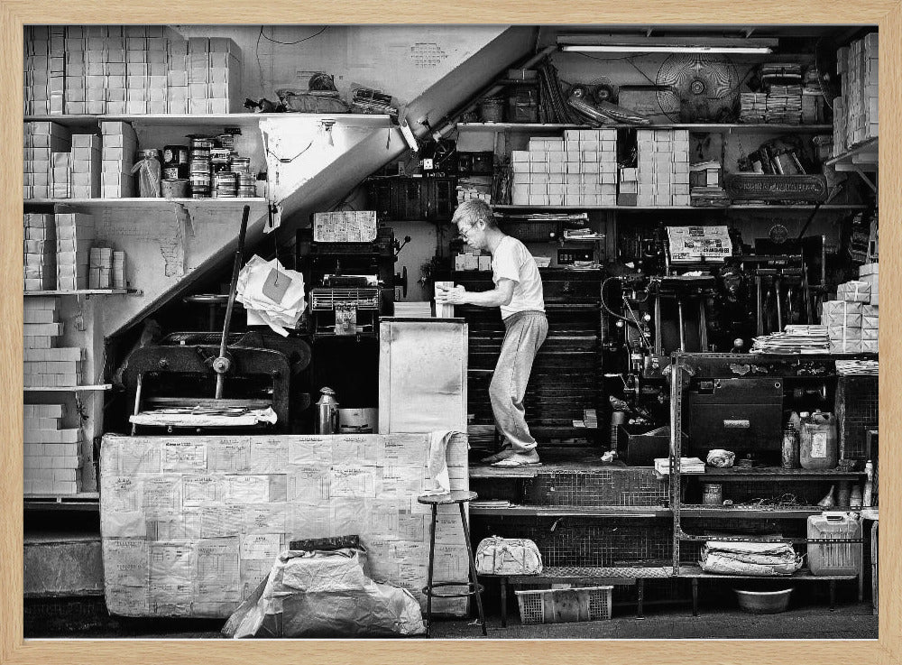 A vintage art print depicting a small, old-fashioned printing shop interior, showcasing antique machinery and a nostalgic atmosphere. Artwork