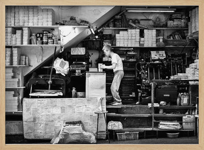 A vintage art print depicting a small, old-fashioned printing shop interior, showcasing antique machinery and a nostalgic atmosphere. Artwork