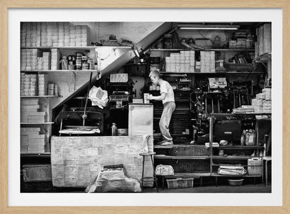 A vintage art print depicting a small, old-fashioned printing shop interior, showcasing antique machinery and a nostalgic atmosphere. Artwork