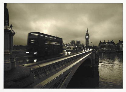 A framed, sepia-toned long-exposure photograph of London. A double-decker bus is shown in motion blur as it crosses Westminster Bridge. In the background, the Big Ben clock tower and the Houses of Parliament are visible against a cloudy sky, with lights reflecting on the wet road and the River Thames. Wall Art