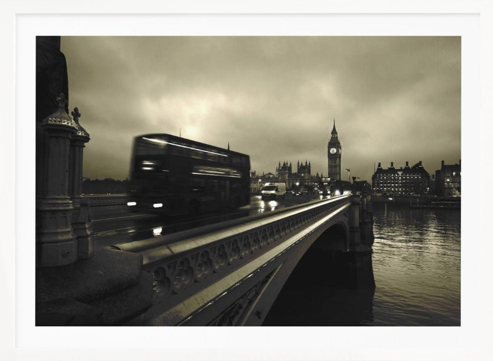 A framed, sepia-toned long-exposure photograph of London. A double-decker bus is shown in motion blur as it crosses Westminster Bridge. In the background, the Big Ben clock tower and the Houses of Parliament are visible against a cloudy sky, with lights reflecting on the wet road and the River Thames. Wall Art