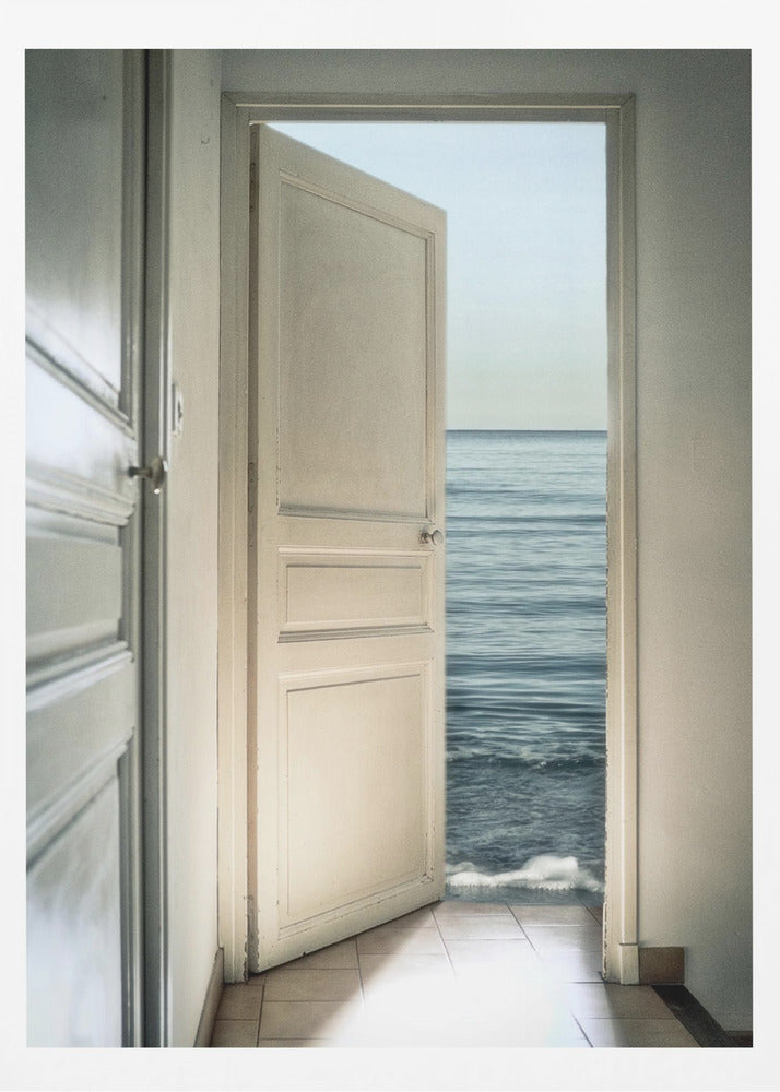 A surreal photograph showing a white interior door swung open, revealing not a landscape but the vast blue ocean, with waves gently washing over the tiled floor of the room. Decor
