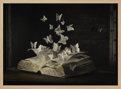 A conceptual artwork depicting an open vintage book on a dark wooden table. Dozens of butterflies, crafted from the book's own printed pages, are emerging and flying upwards as if the story is coming to life against a dark, rustic background. Artwork