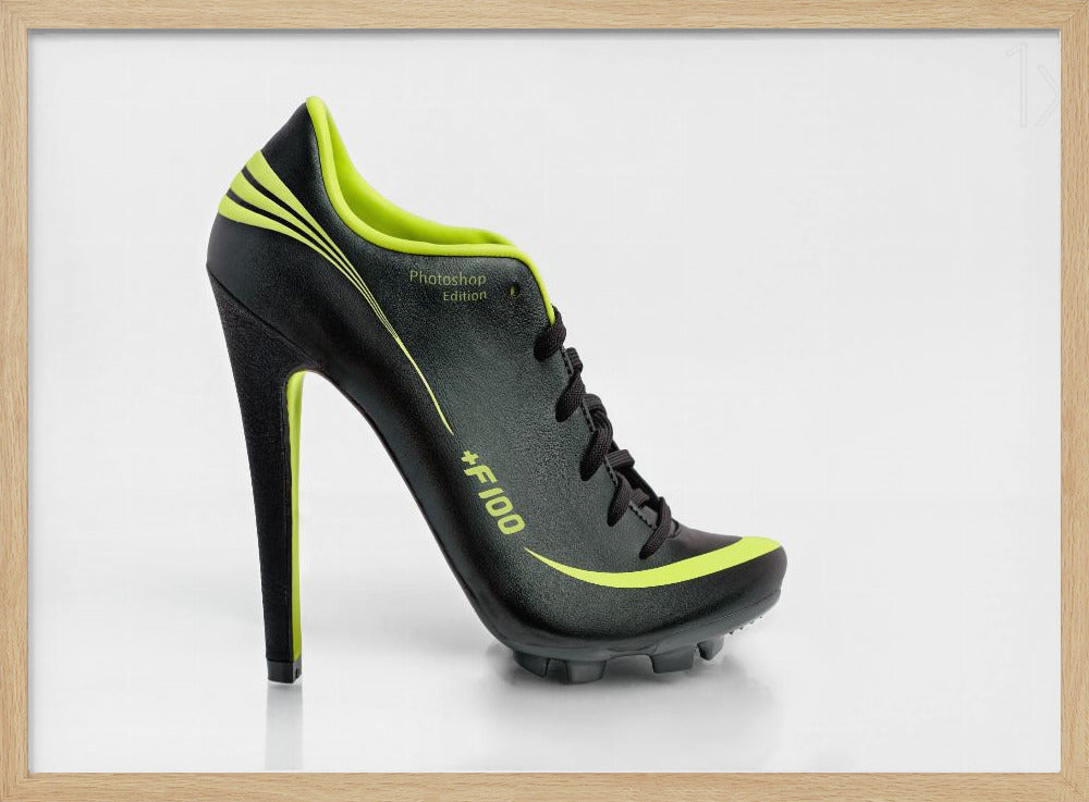 A conceptual piece of digital art featuring a hybrid shoe that is part black soccer cleat and part stiletto high heel. The shoe has neon lime green accents and is displayed against a stark white background inside a silver frame. Decor