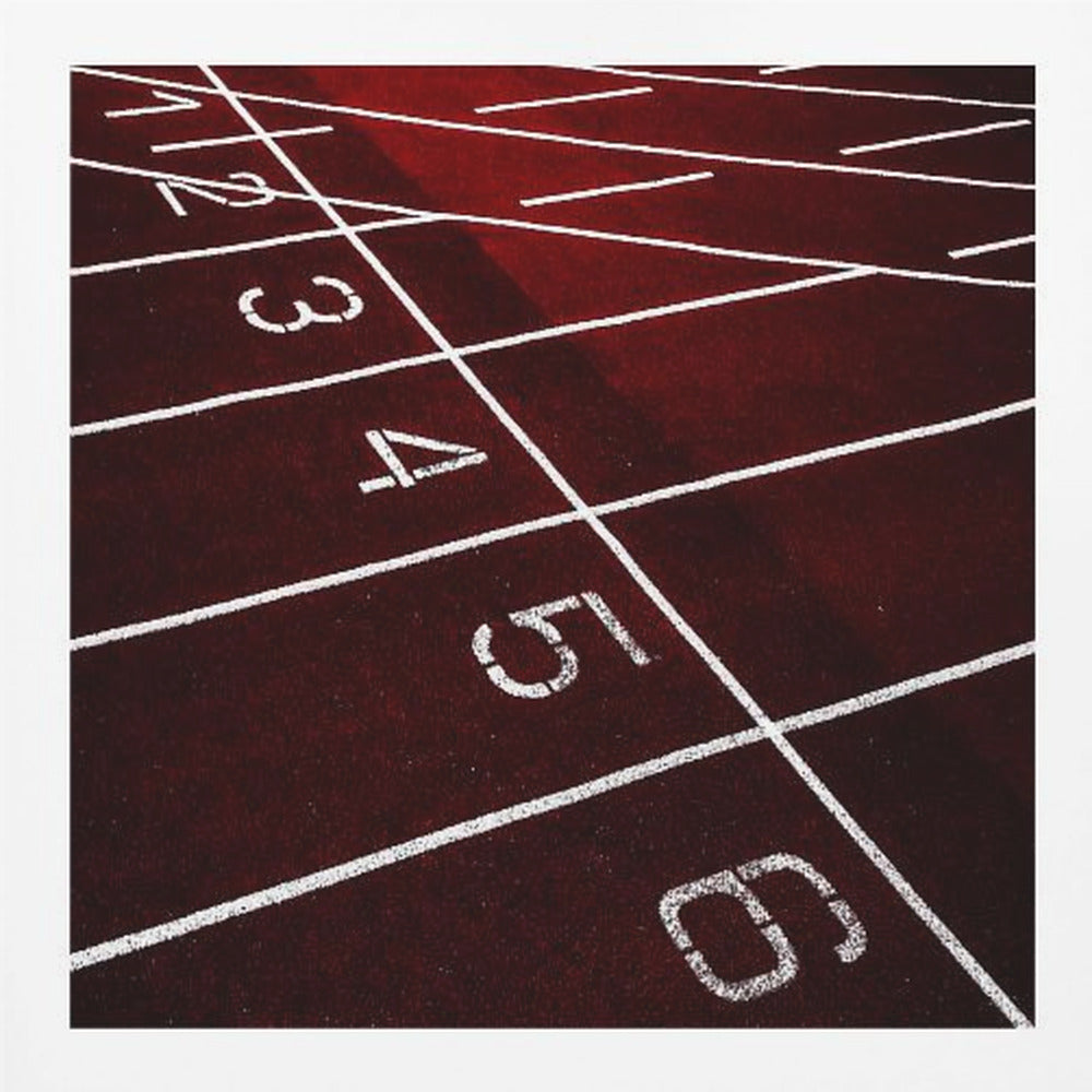 A framed, high-angle photograph of a deep red running track, showing the white lines and numbers for lanes one through six creating a grid-like pattern. Poster