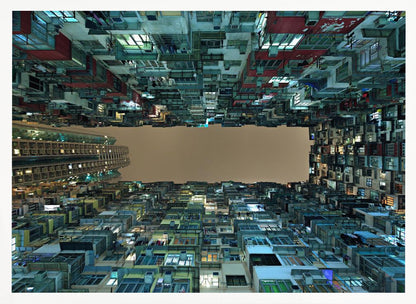 A framed, low-angle photograph looking up from a courtyard at densely packed, colorful apartment buildings that form a rectangle around a blank, overcast sky at night. Print
