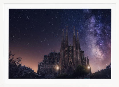 A fantastical night view of the Sagrada Familia in Barcelona, its intricate spires reaching up towards a magnificent, starry sky filled with the purple and pink hues of the Milky Way galaxy, all enclosed in a silver frame. Artwork