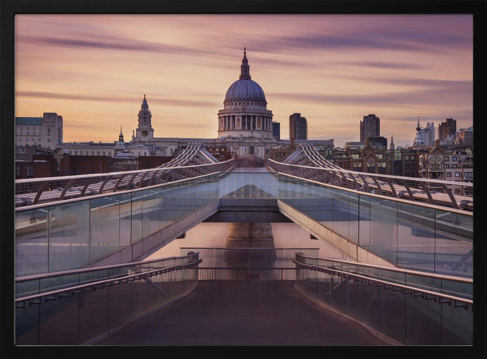 A photograph looking down the center of the Millennium Bridge in London, leading the eye directly to St. Paul's Cathedral, which is centered in the background under a beautiful purple and orange sunset sky. Print