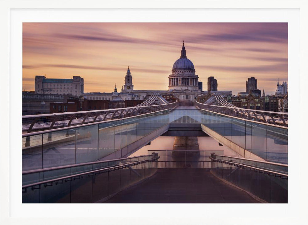 A photograph looking down the center of the Millennium Bridge in London, leading the eye directly to St. Paul's Cathedral, which is centered in the background under a beautiful purple and orange sunset sky. Print