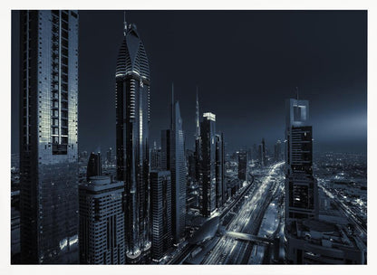 A framed, blue-toned nighttime photograph of a futuristic city skyline from an elevated perspective, featuring illuminated skyscrapers and light trails from traffic on a major highway stretching into the distance. Poster