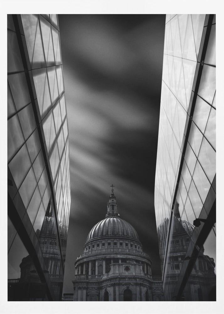 A dramatic black and white, low-angle photograph of St. Paul's Cathedral in London, framed between two modern, reflective glass skyscrapers. A long exposure effect blurs the clouds in the sky, creating streaks of light and shadow behind the cathedral's dome. Poster