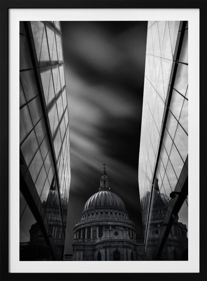 A dramatic black and white, low-angle photograph of St. Paul's Cathedral in London, framed between two modern, reflective glass skyscrapers. A long exposure effect blurs the clouds in the sky, creating streaks of light and shadow behind the cathedral's dome. Poster