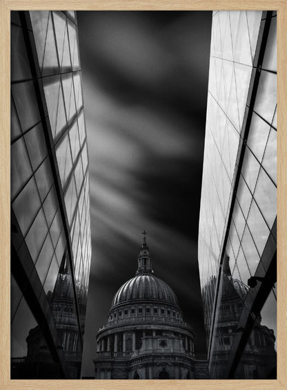 A dramatic black and white, low-angle photograph of St. Paul's Cathedral in London, framed between two modern, reflective glass skyscrapers. A long exposure effect blurs the clouds in the sky, creating streaks of light and shadow behind the cathedral's dome. Poster
