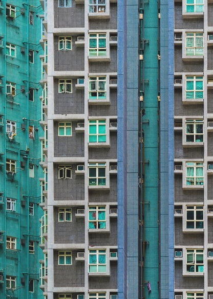 A striking close-up of two densely packed apartment buildings, one with a teal tiled facade and the other with a grey and blue tiled facade, creating a strong pattern of repeating windows and geometric lines. Decor