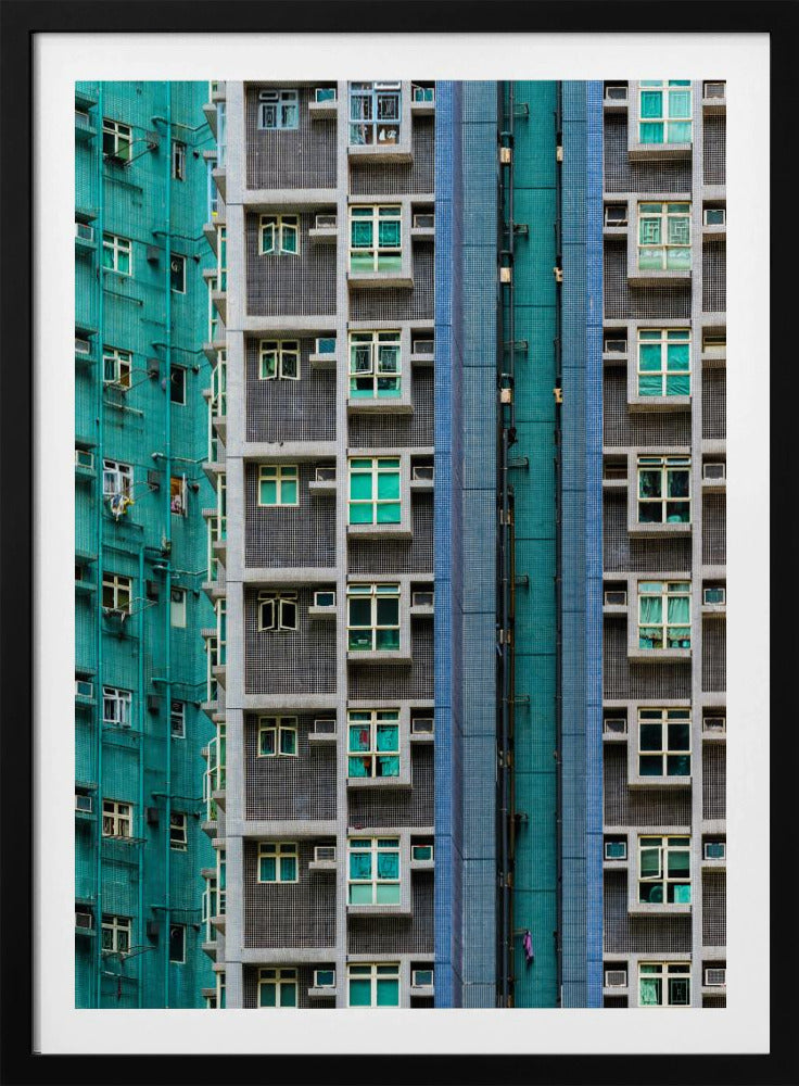 A striking close-up of two densely packed apartment buildings, one with a teal tiled facade and the other with a grey and blue tiled facade, creating a strong pattern of repeating windows and geometric lines. Decor