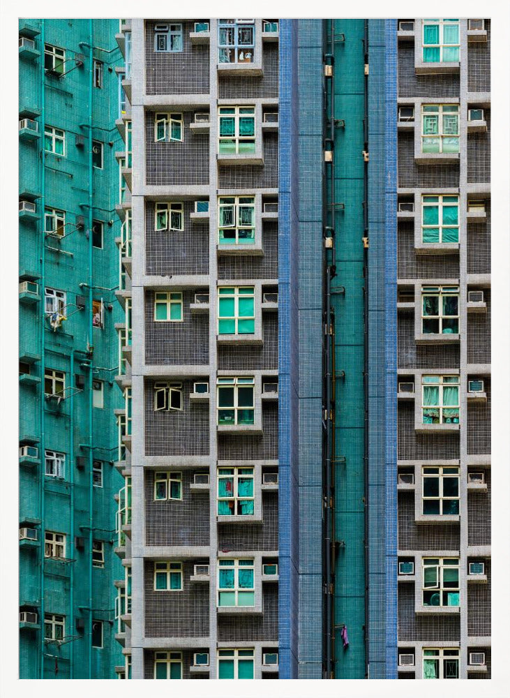 A striking close-up of two densely packed apartment buildings, one with a teal tiled facade and the other with a grey and blue tiled facade, creating a strong pattern of repeating windows and geometric lines. Decor