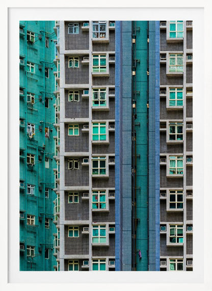 A striking close-up of two densely packed apartment buildings, one with a teal tiled facade and the other with a grey and blue tiled facade, creating a strong pattern of repeating windows and geometric lines. Decor
