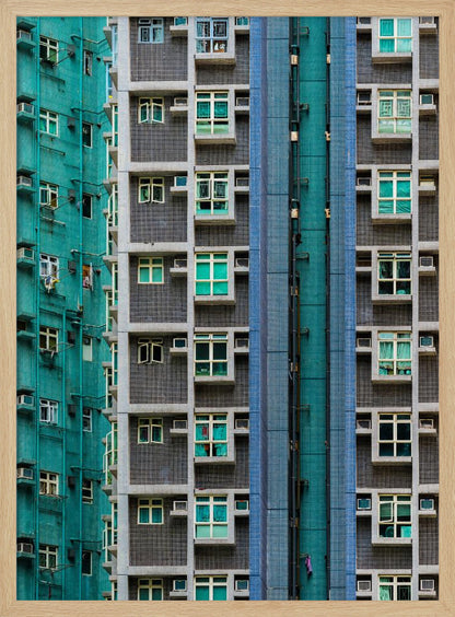 A striking close-up of two densely packed apartment buildings, one with a teal tiled facade and the other with a grey and blue tiled facade, creating a strong pattern of repeating windows and geometric lines. Decor