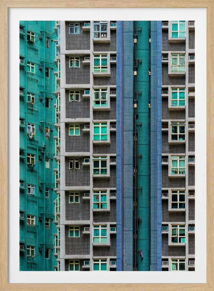 A striking close-up of two densely packed apartment buildings, one with a teal tiled facade and the other with a grey and blue tiled facade, creating a strong pattern of repeating windows and geometric lines. Decor