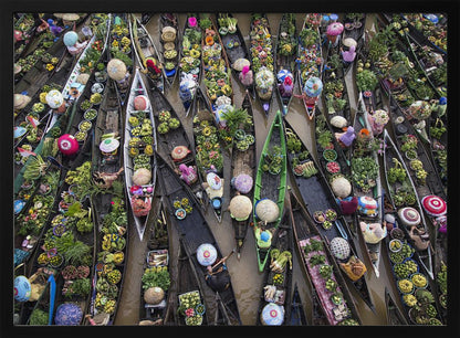 An aerial photograph of a crowded floating market in Southeast Asia, with dozens of narrow wooden boats filled with vibrant green produce and colorful wares on a brown river. Poster