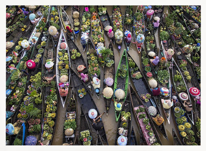 An aerial photograph of a crowded floating market in Southeast Asia, with dozens of narrow wooden boats filled with vibrant green produce and colorful wares on a brown river. Poster