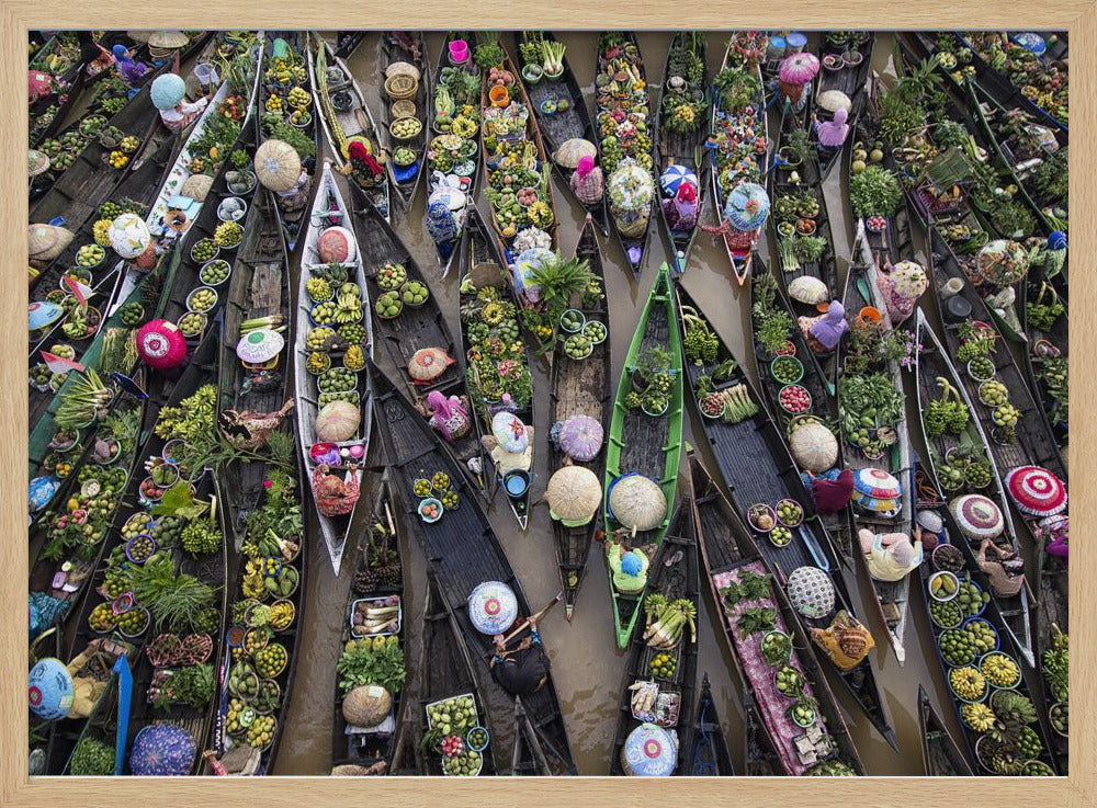 An aerial photograph of a crowded floating market in Southeast Asia, with dozens of narrow wooden boats filled with vibrant green produce and colorful wares on a brown river. Poster