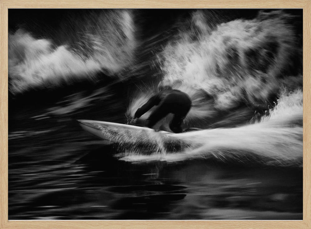A dynamic black and white action photograph of a surfer in a dark wetsuit, crouched low on a surfboard while riding a powerful wave. Motion blur captures the speed and energy of the moment, with white water spray exploding around the surfer against the dark ocean. Print